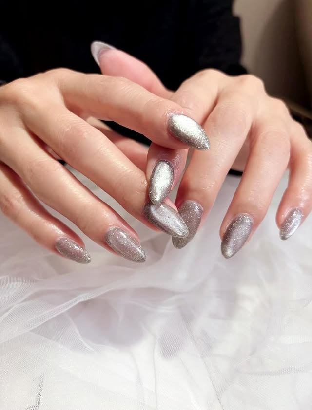 15. Silver Cat Eye Almond Nails - silver nail ideas