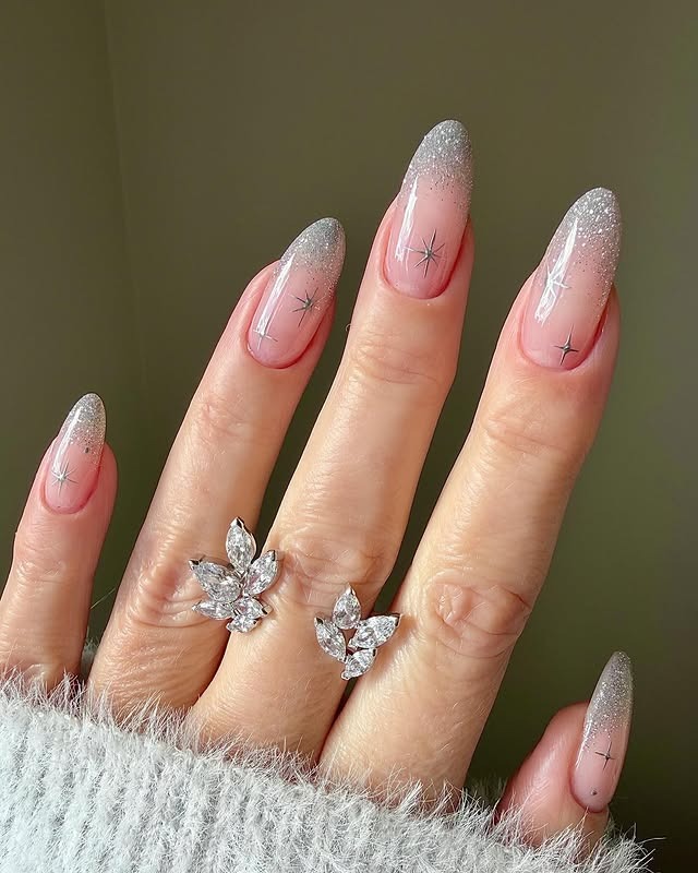 18. Silver Glitter Ombre Almond Nails with Star Accents - silver nail ideas