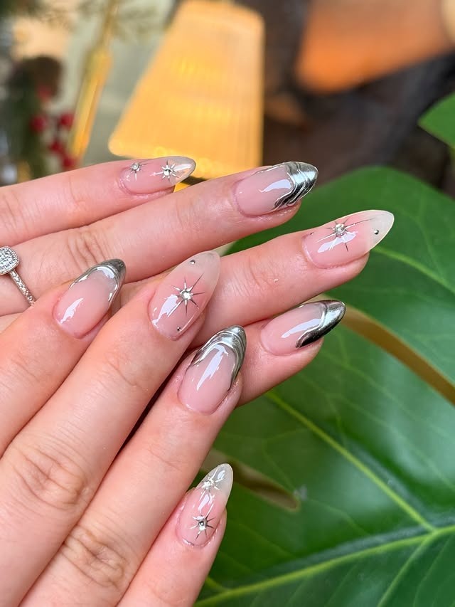 21. Silver Chrome French Almond Nails with Starburst Accents - silver nail ideas