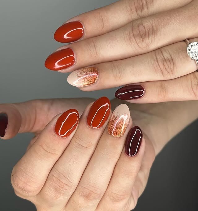 2. Burnt Orange and Burgundy Glossy Almond Nails with Glitter Accent - simple fall nail ideas