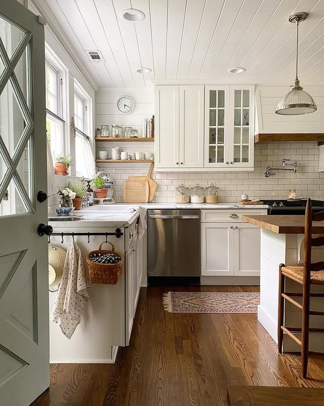 4. Classic Farmhouse White Kitchen with Natural Wood Floors - simple kitchen ideas
