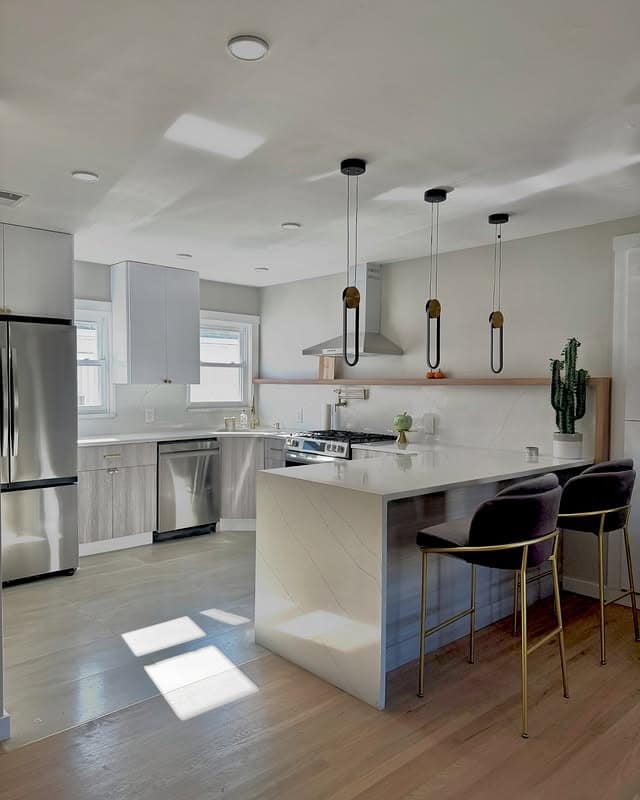 6. Contemporary White and Wood Kitchen with Waterfall Island - simple kitchen ideas