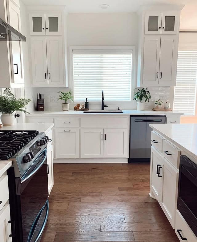 7. Bright White Kitchen with Black Hardware and Warm Wood Floors - simple kitchen ideas