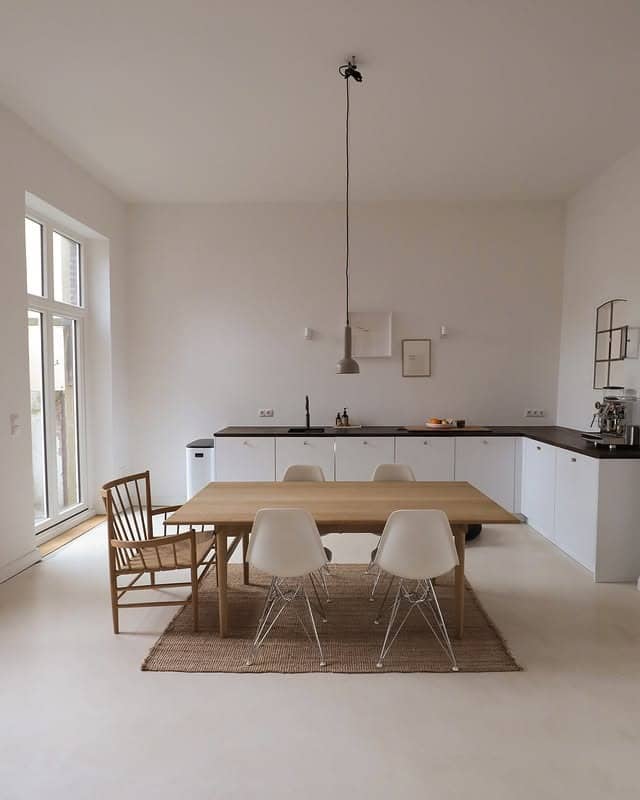 9. Minimalist White Kitchen with Natural Wood Dining Space - simple kitchen ideas