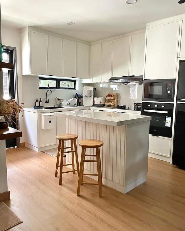19. Modern White Kitchen with Fluted Island and Light Oak Floors - simple kitchen ideas