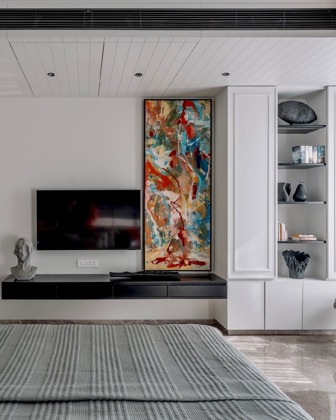 7. Modern TV Wall with Built-In Display Shelving - tv in bedroom ideas