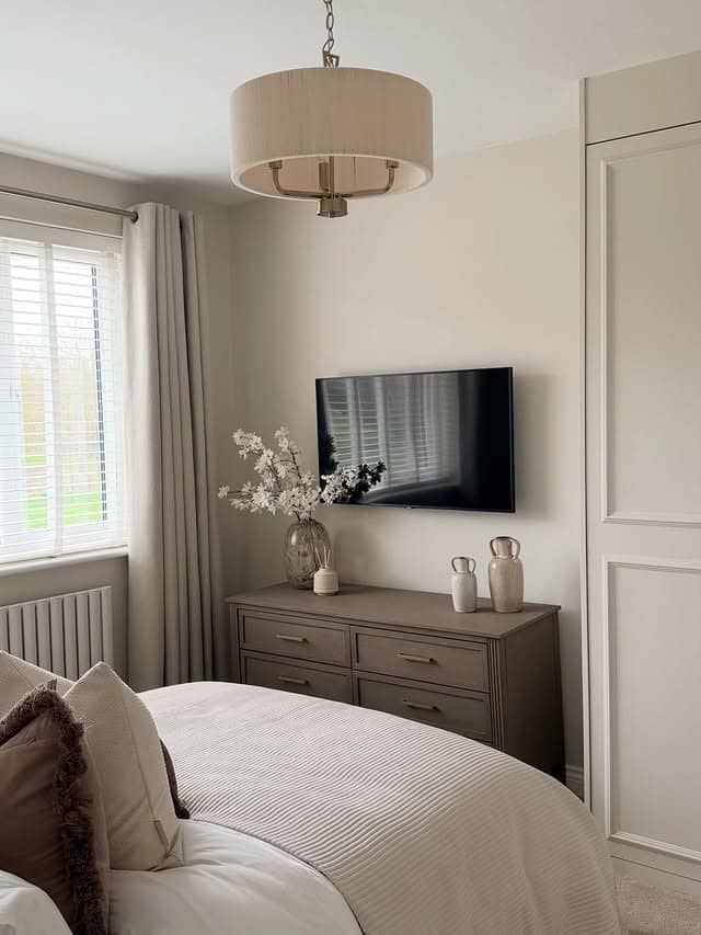 9. Soft Neutral Bedroom with Dresser TV Setup - tv in bedroom ideas
