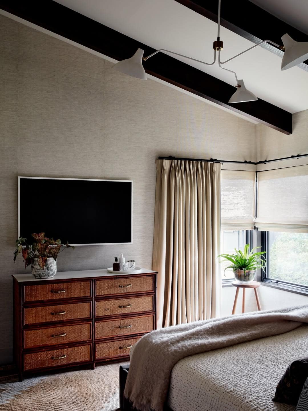 14. Classic Walnut Dresser TV Setup with Neutral Tones - tv in bedroom ideas