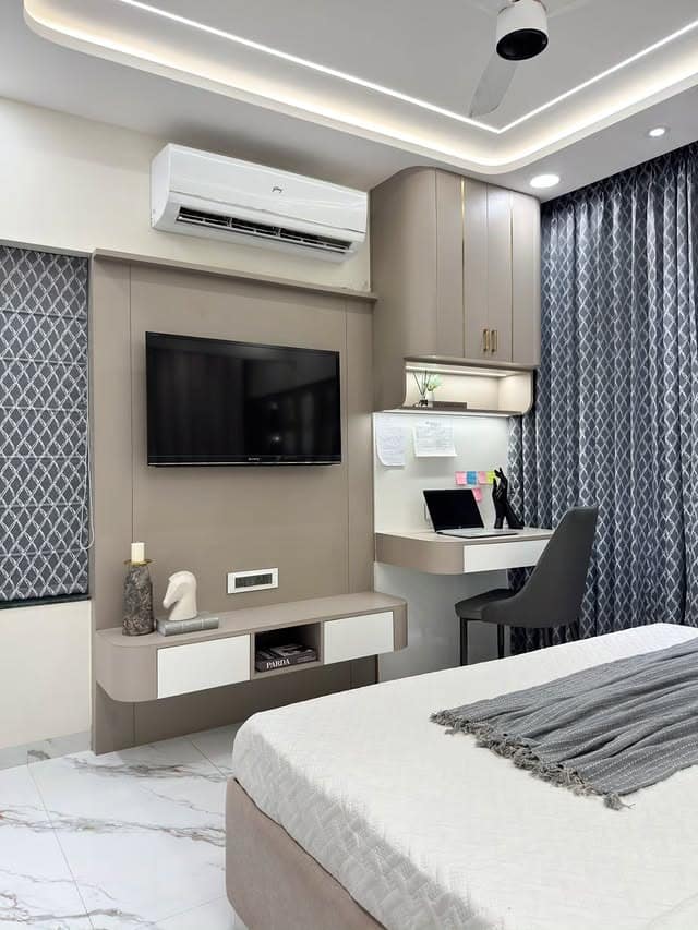 21. Greige TV Wall with Built-In Study Corner - tv in bedroom ideas