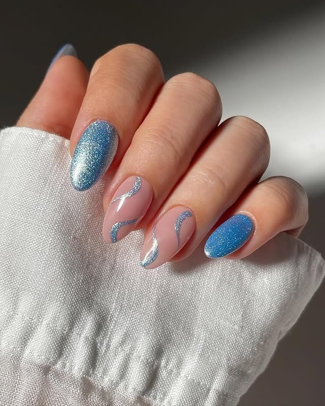 3. Ice Blue Glitter Swirl Almond Nails - sparkly nail ideas