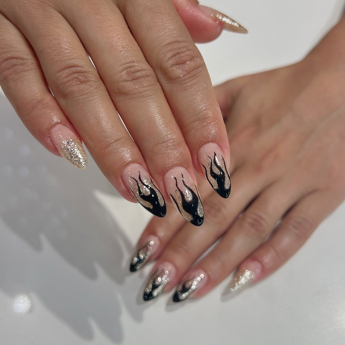 7. Black Flame Glitter Almond Nails - sparkly nail ideas