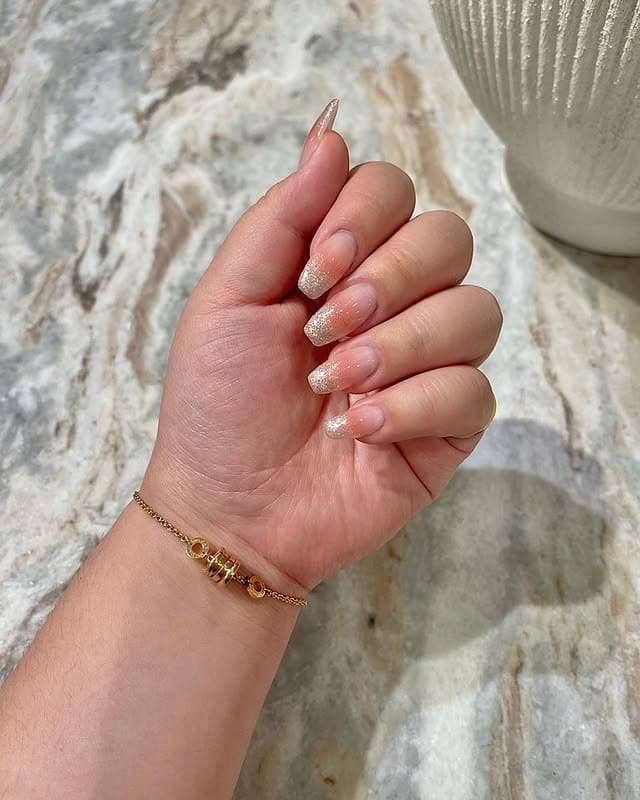 10. Champagne Glitter Ombre Almond Nails - sparkly nail ideas