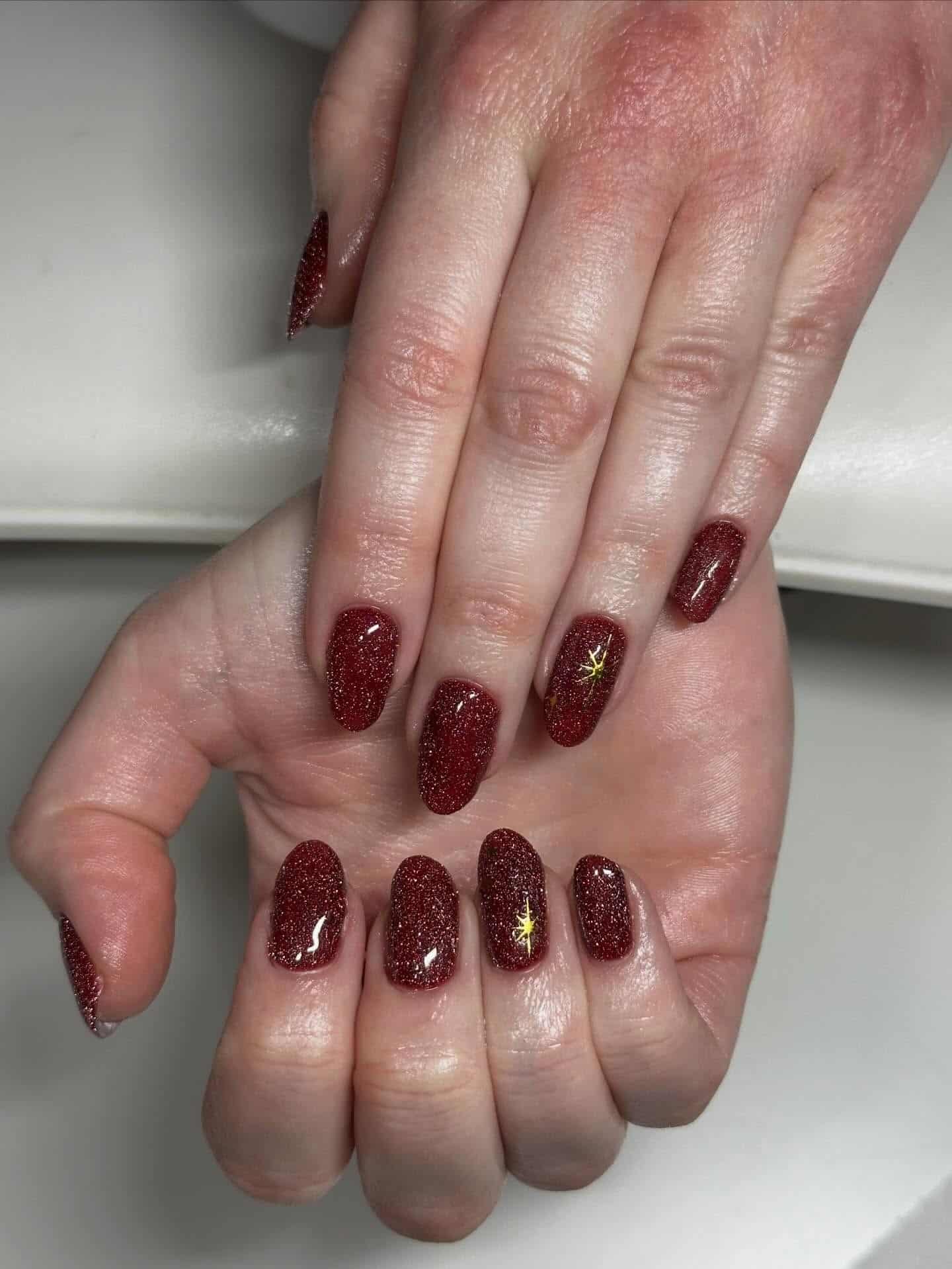 14. Deep Burgundy Glitter Oval Nails - sparkly nail ideas