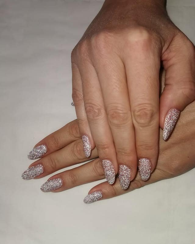 15. Champagne Silver Glitter Almond Nails - sparkly nail ideas