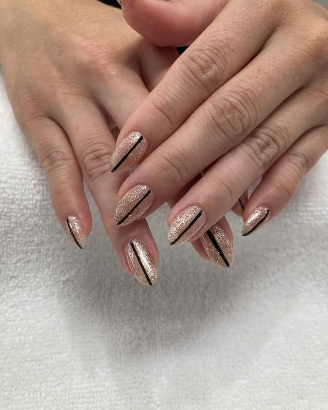 17. Champagne Glitter Almond Nails with Black Stripe Accents - sparkly nail ideas