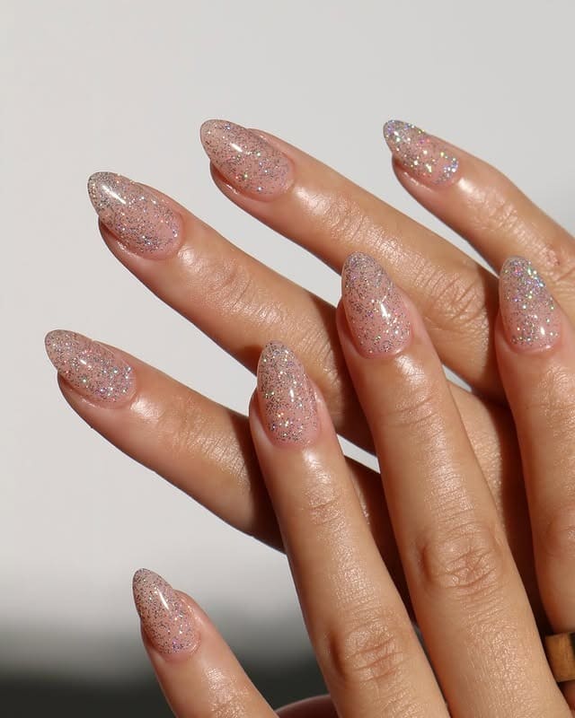 22. Sheer Nude Iridescent Glitter Almond Nails - sparkly nail ideas