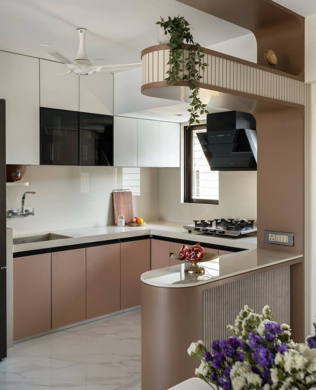 9. Cream and Blush Modern Kitchen with Curved Breakfast Bar - light color kitchen ideas