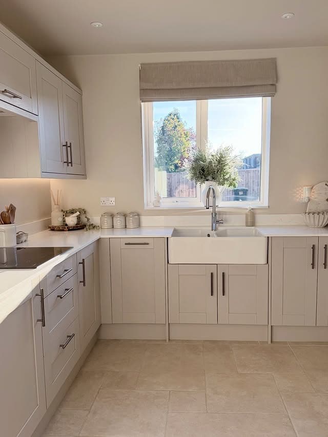 18. Soft Beige Shaker Kitchen with Farmhouse Sink - light color kitchen ideas