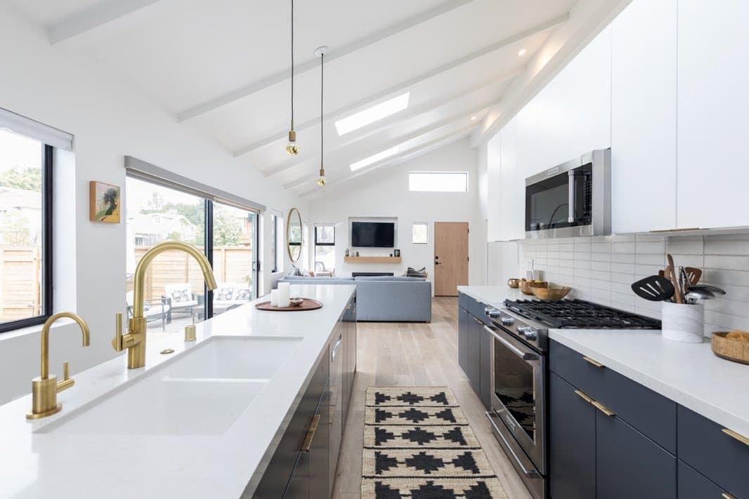 1. White and Charcoal Narrow Kitchen with Brass Accents - narrow kitchen ideas
