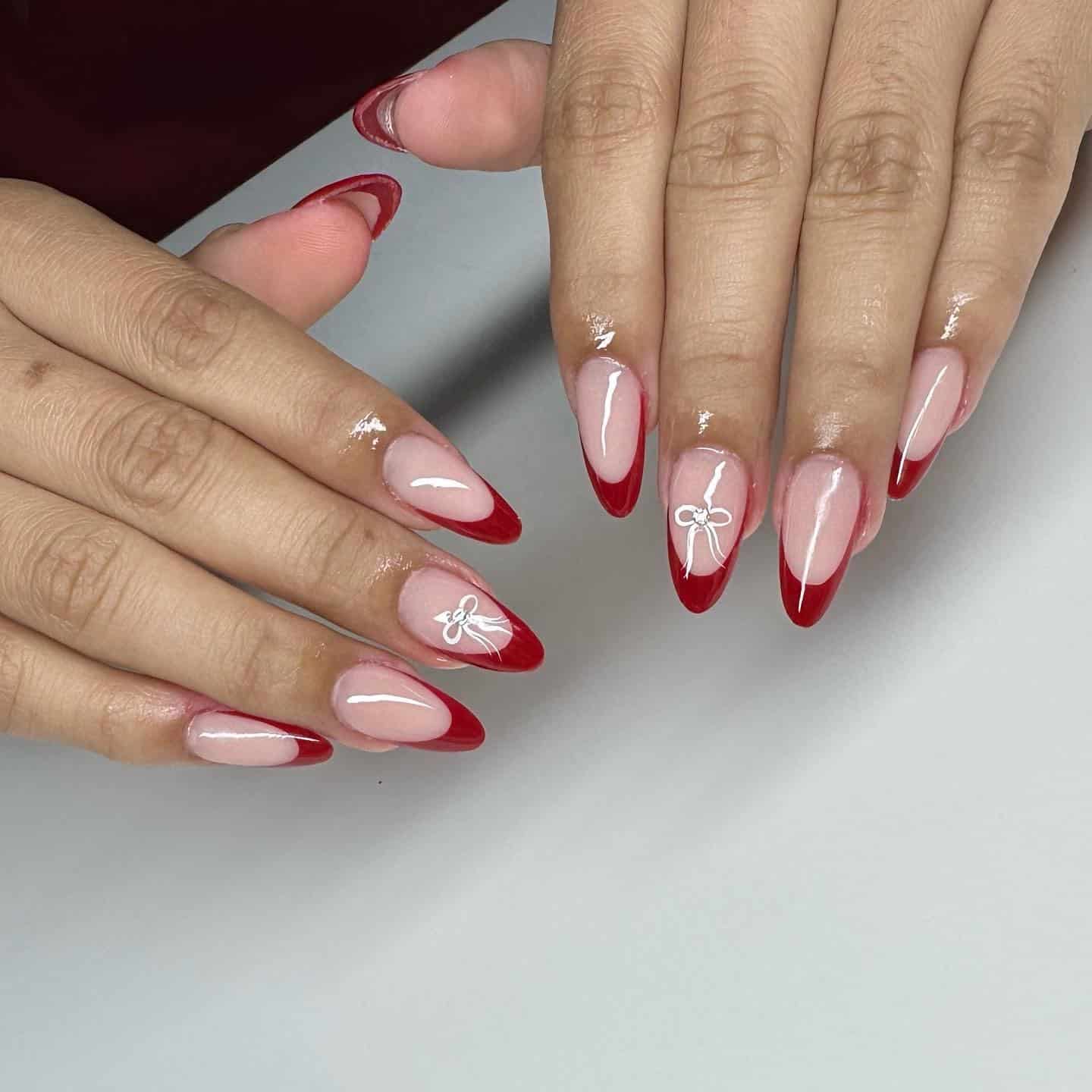 17. Deep Red French Almond Nails with Bow Art - trendy simple nail ideas