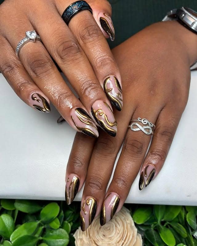 8. Black and Gold Swirl Almond Nails - black and gold nail ideas