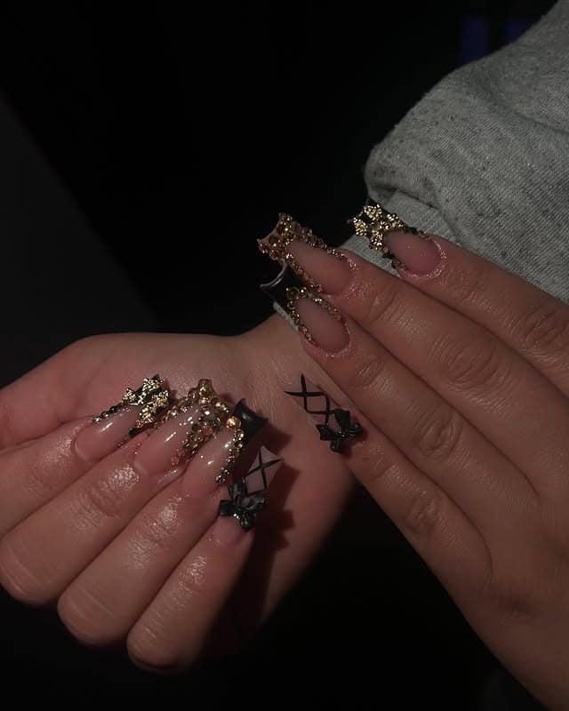 9. Black Gothic Nails with Gold Charms - black and gold nail ideas
