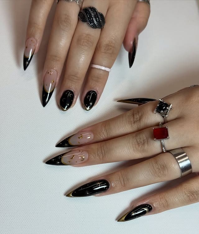 10. Black Stiletto French Nails with Gold Celestial Details - black and gold nail ideas