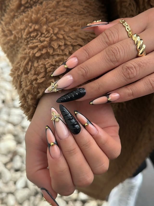 11. Black French Stiletto Nails with Gold Charms - black and gold nail ideas