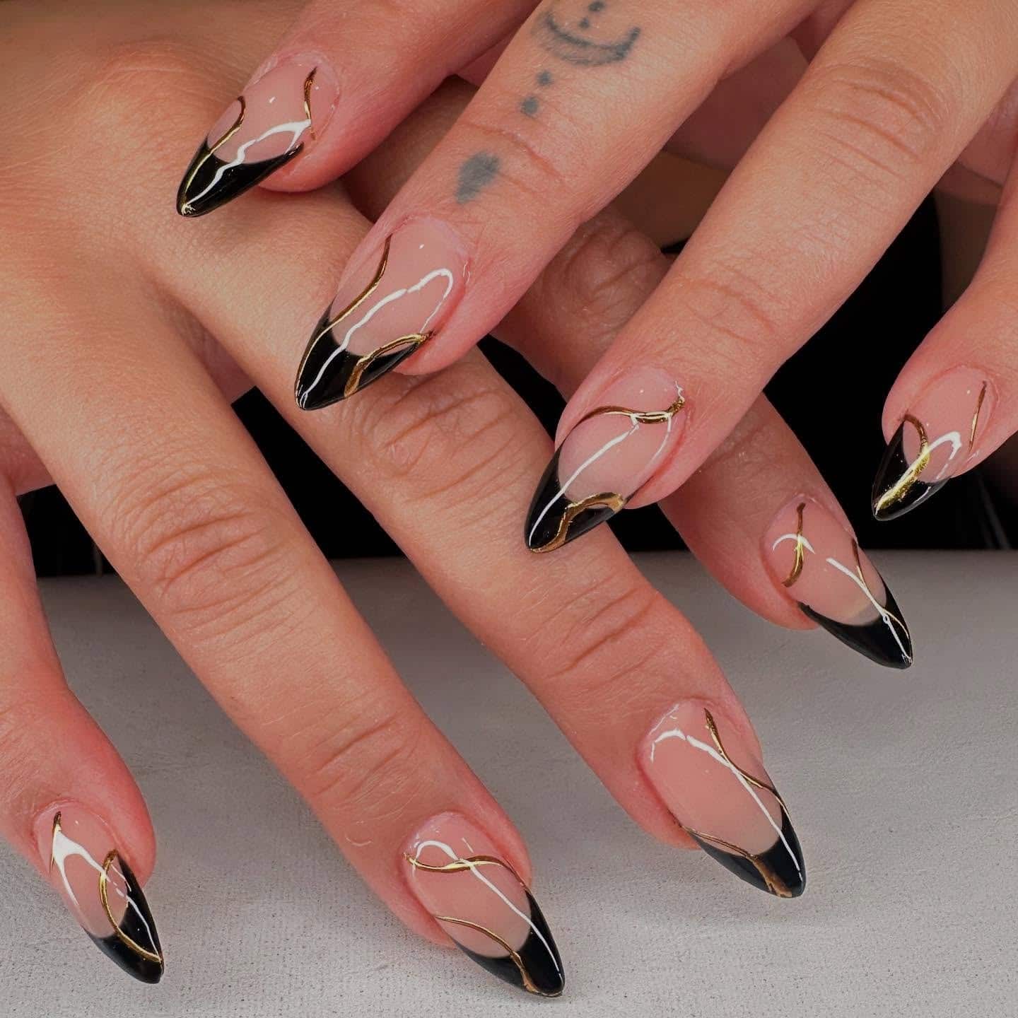 12. Black French Almond Nails with Gold Swirl Lines - black and gold nail ideas