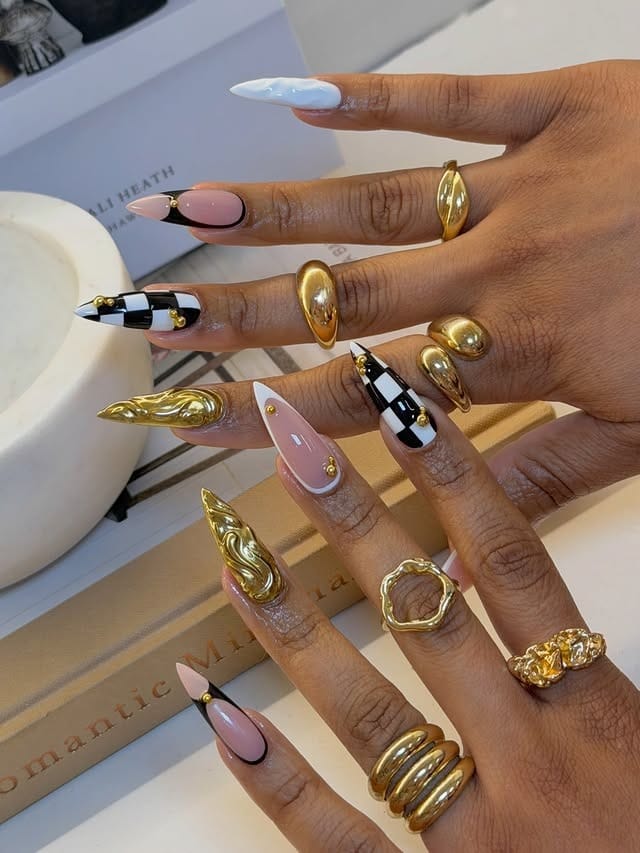 16. Black and Gold Chrome Stiletto Nails - black and gold nail ideas