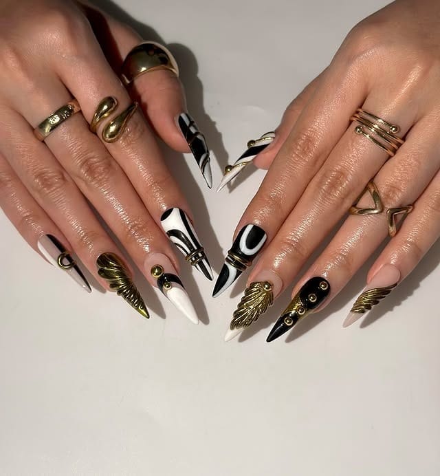 17. Black Abstract Stiletto Nails with Gold Accents - black and gold nail ideas