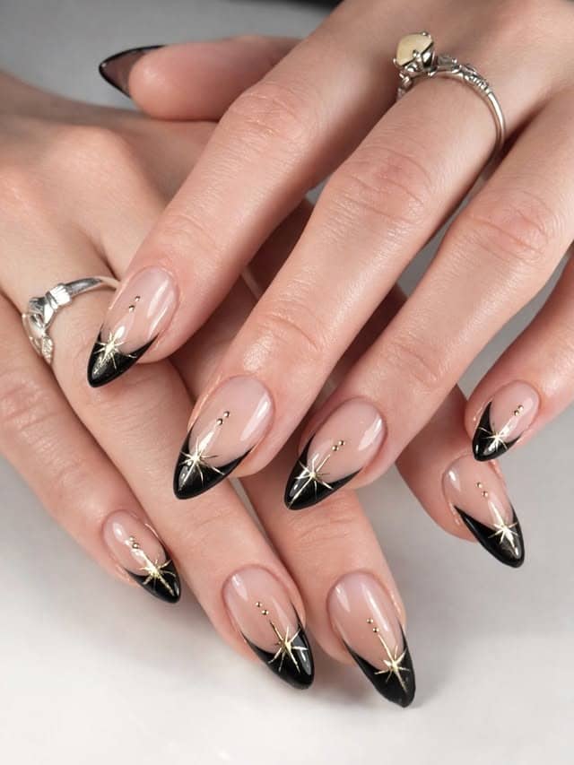 18. Black French Almond Nails with Gold Starbursts - black and gold nail ideas