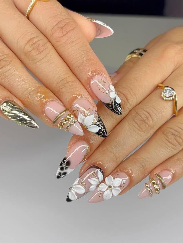 19. Black Floral Almond Nails with Gold Details - black and gold nail ideas