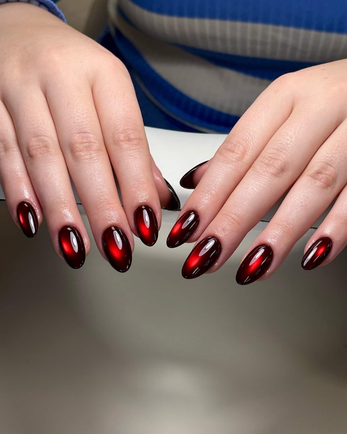 21. Deep Red Cat Eye Almond Nails - cat eye nail ideas