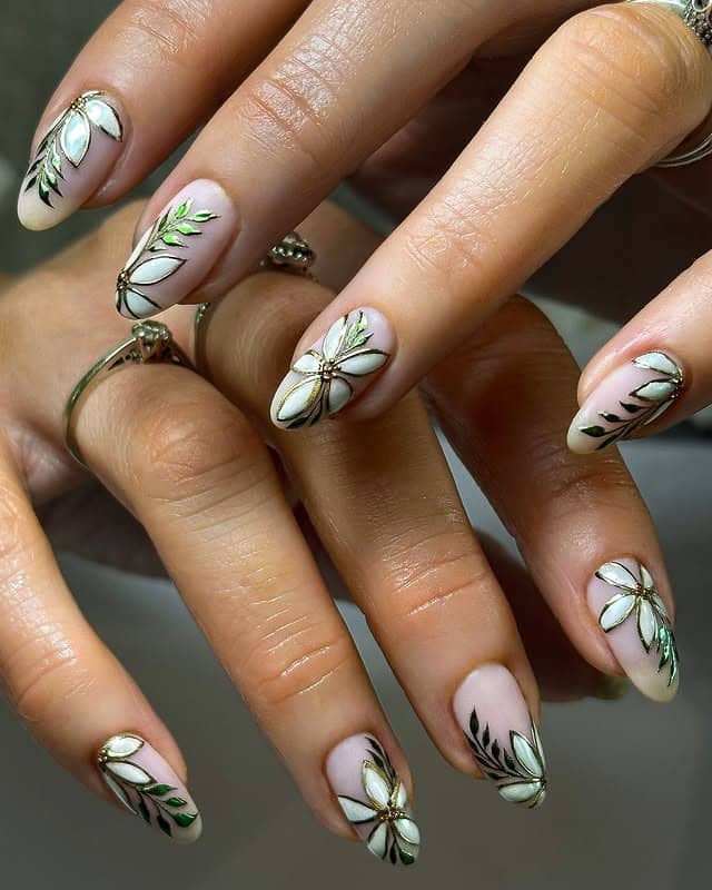 21. White Floral Almond Nails with Green Leaf Accents - creative nail ideas