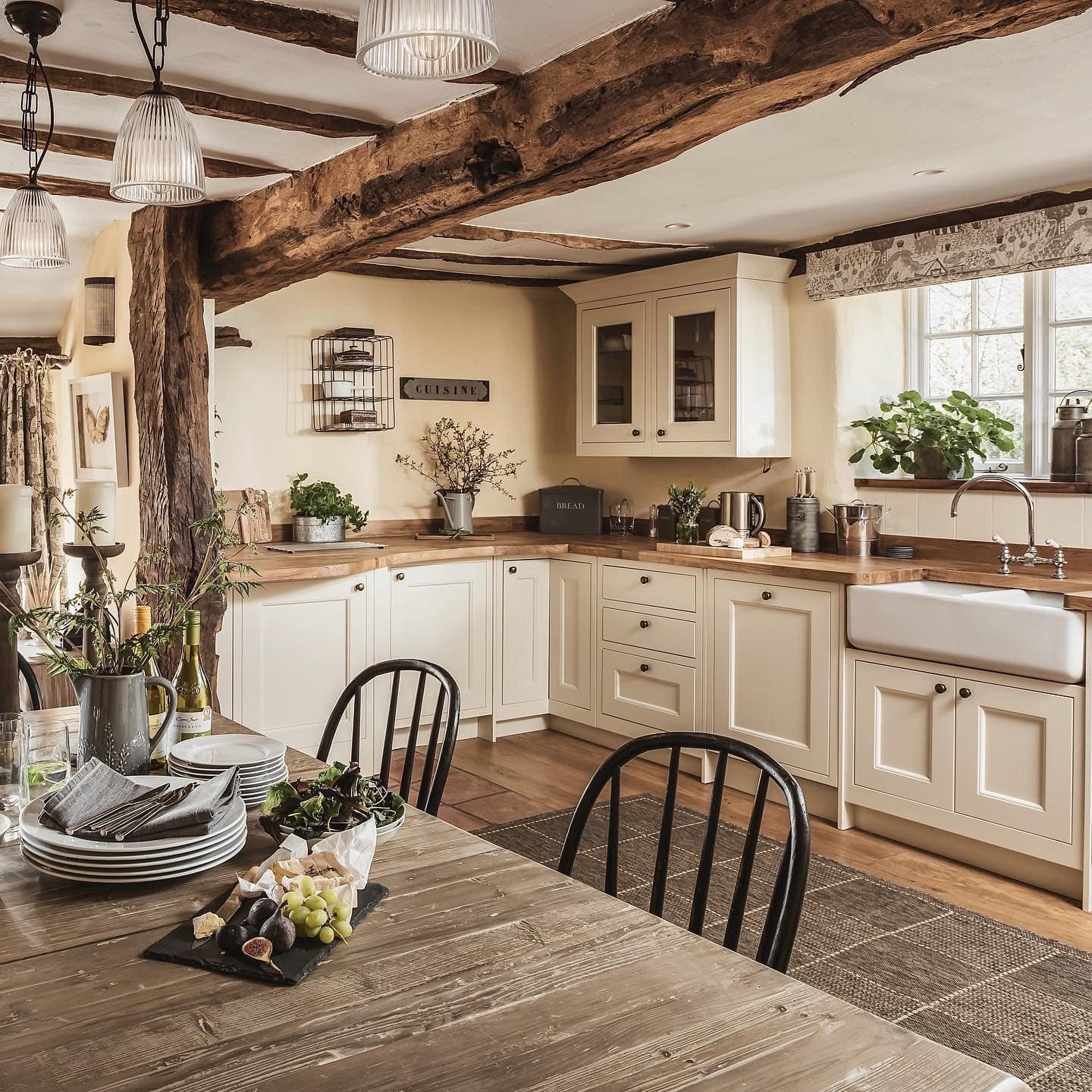 1. Rustic Kitchen Ideas with Cream Cabinets and Warm Wood Beams - rustic kitchen ideas