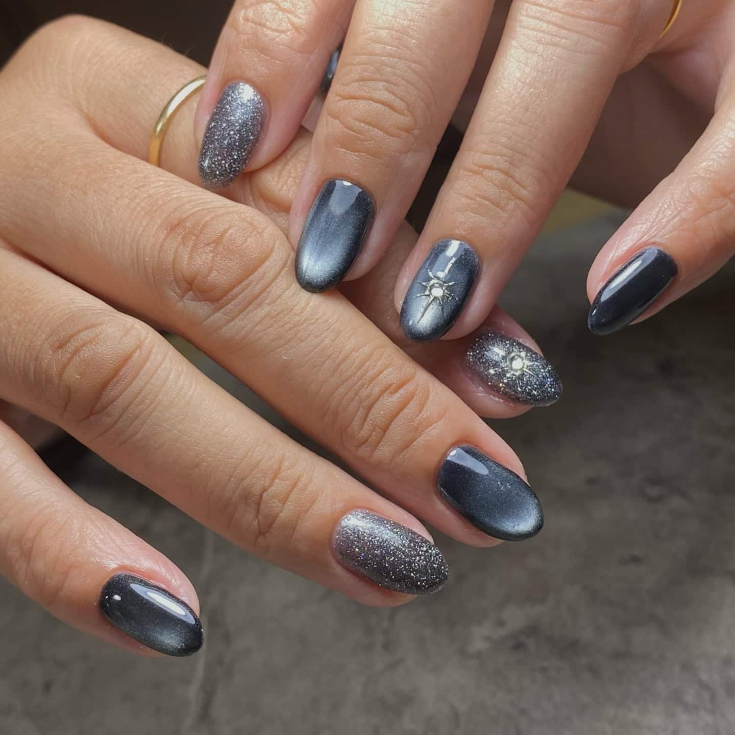 11. Charcoal Cat Eye Galaxy Almond Nails - elegant nail art ideas