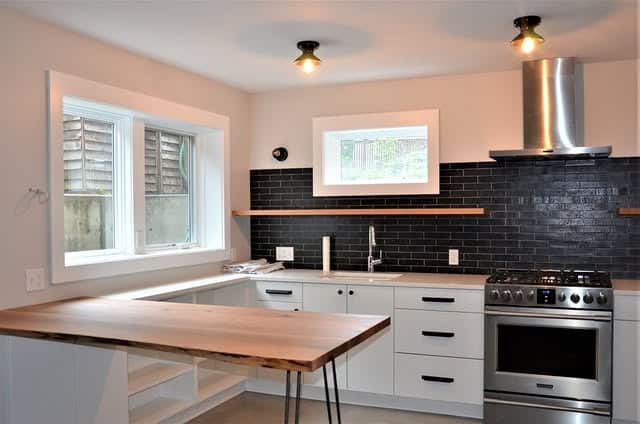 4. White and Black Basement Kitchen with Wood Countertop - basement kitchen ideas
