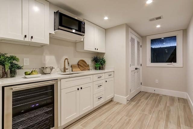 6. Bright White Basement Kitchenette Design - basement kitchen ideas