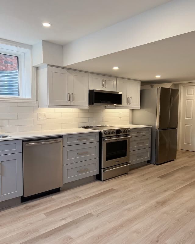 20. Light Gray Basement Kitchen with Stainless Steel Appliances - basement kitchen ideas