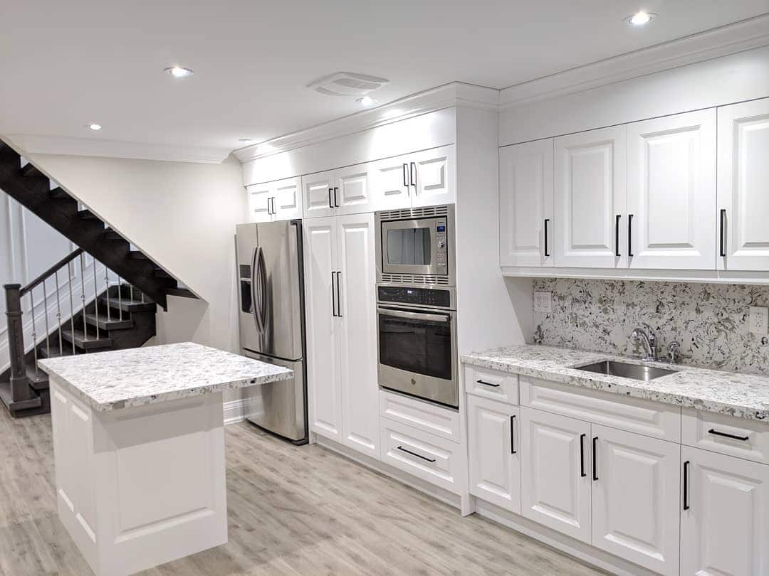 22. Bright White Basement Kitchen with Granite Countertops - basement kitchen ideas