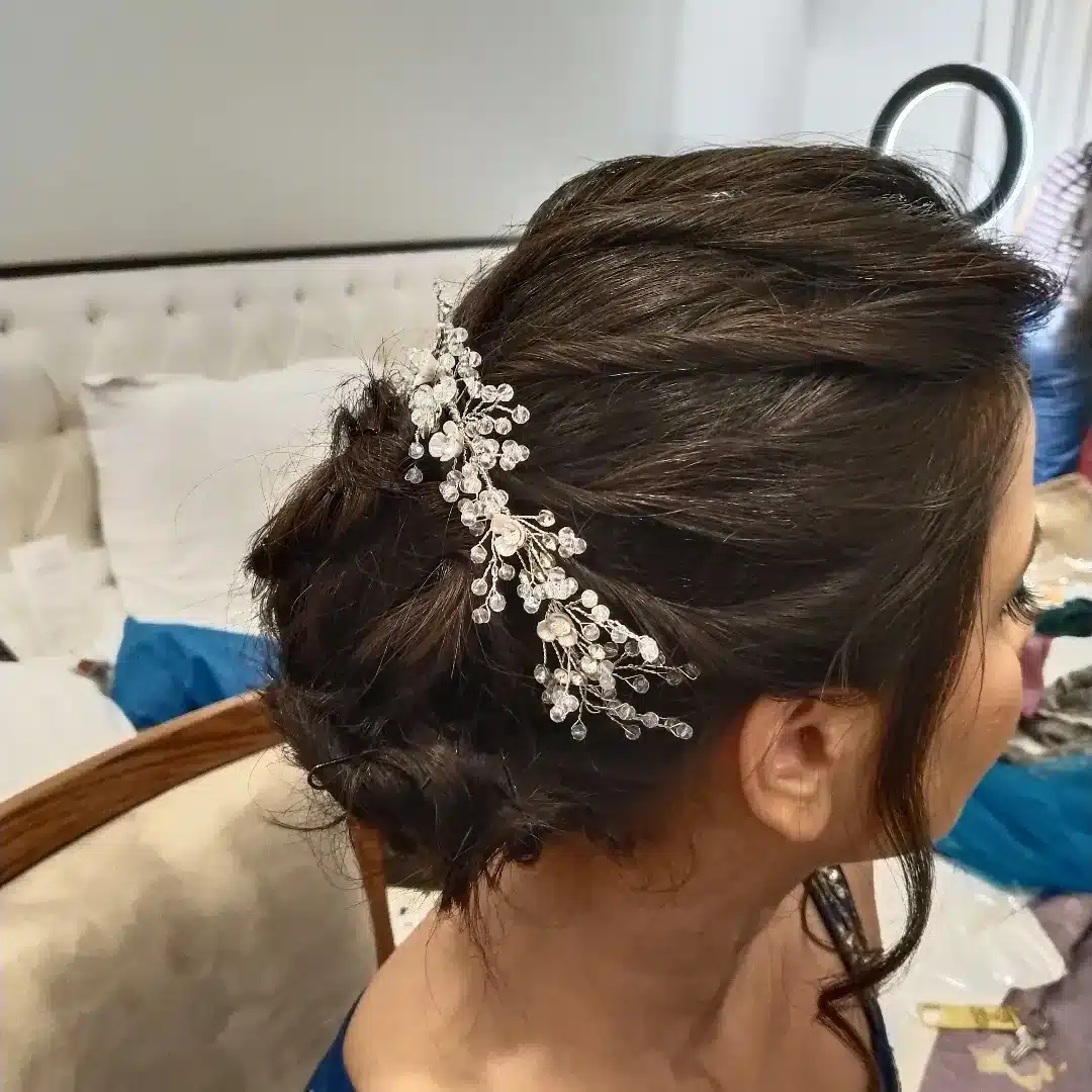 4. Deep Brunette Low Messy Bun with Crystal Hair Vine - Messy Bun Hairstyles