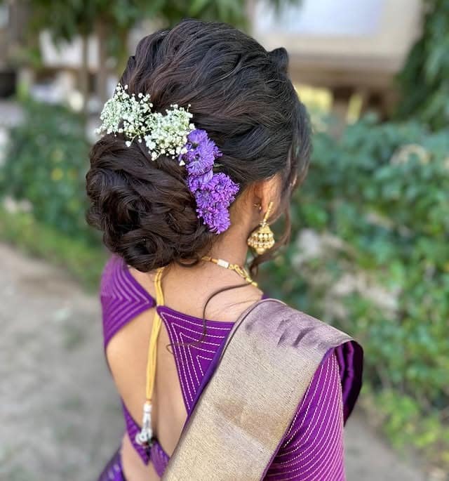 5. Soft Brown Bridal Messy Bun with Fresh Flowers - Messy Bun Hairstyles