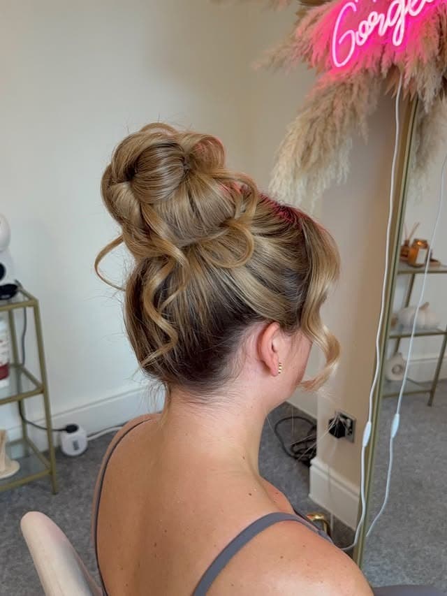 7. Golden Blonde Voluminous Messy Bun - Messy Bun Hairstyles