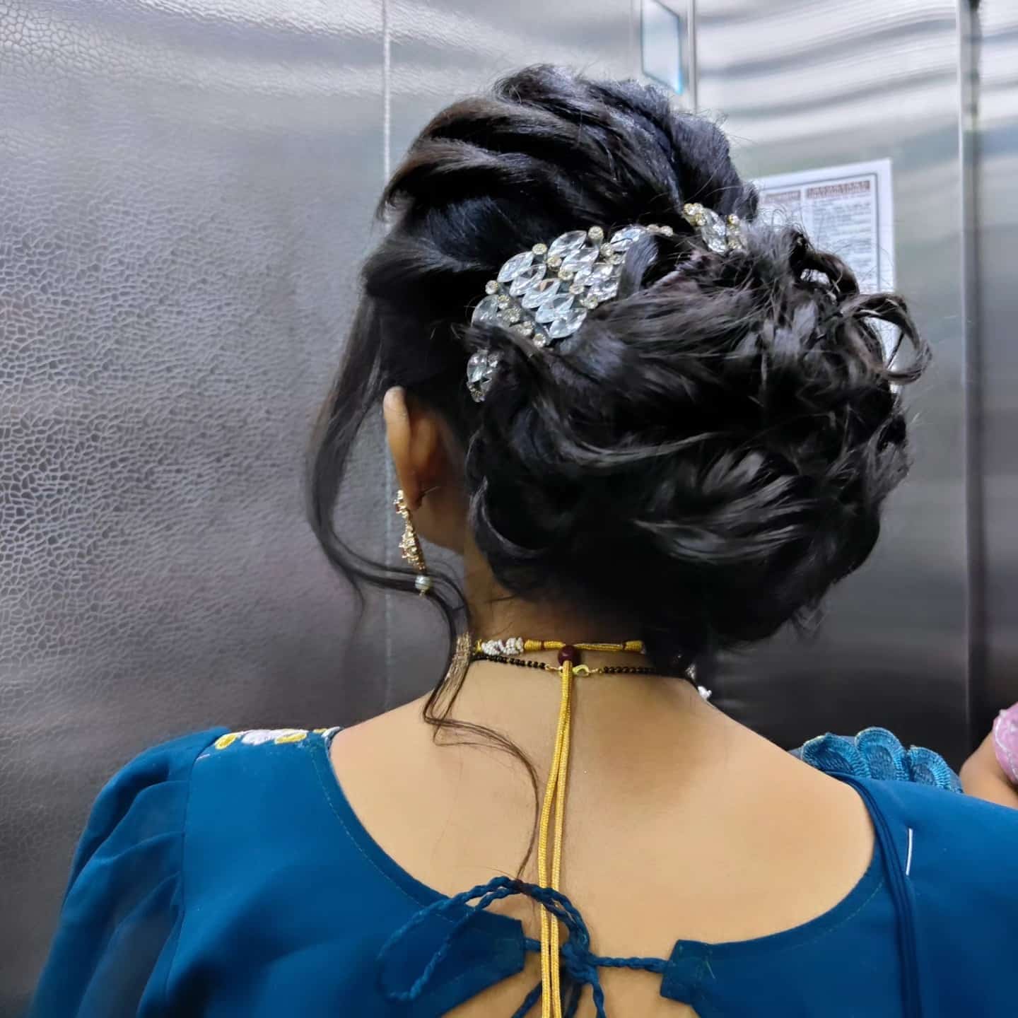 12. Jet Black Textured Messy Bun with Crystal Hair Clip - Messy Bun Hairstyles