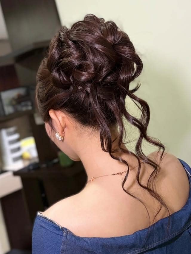 14. Rich Mahogany Messy Bun with Loose Spiral Curls - Messy Bun Hairstyles