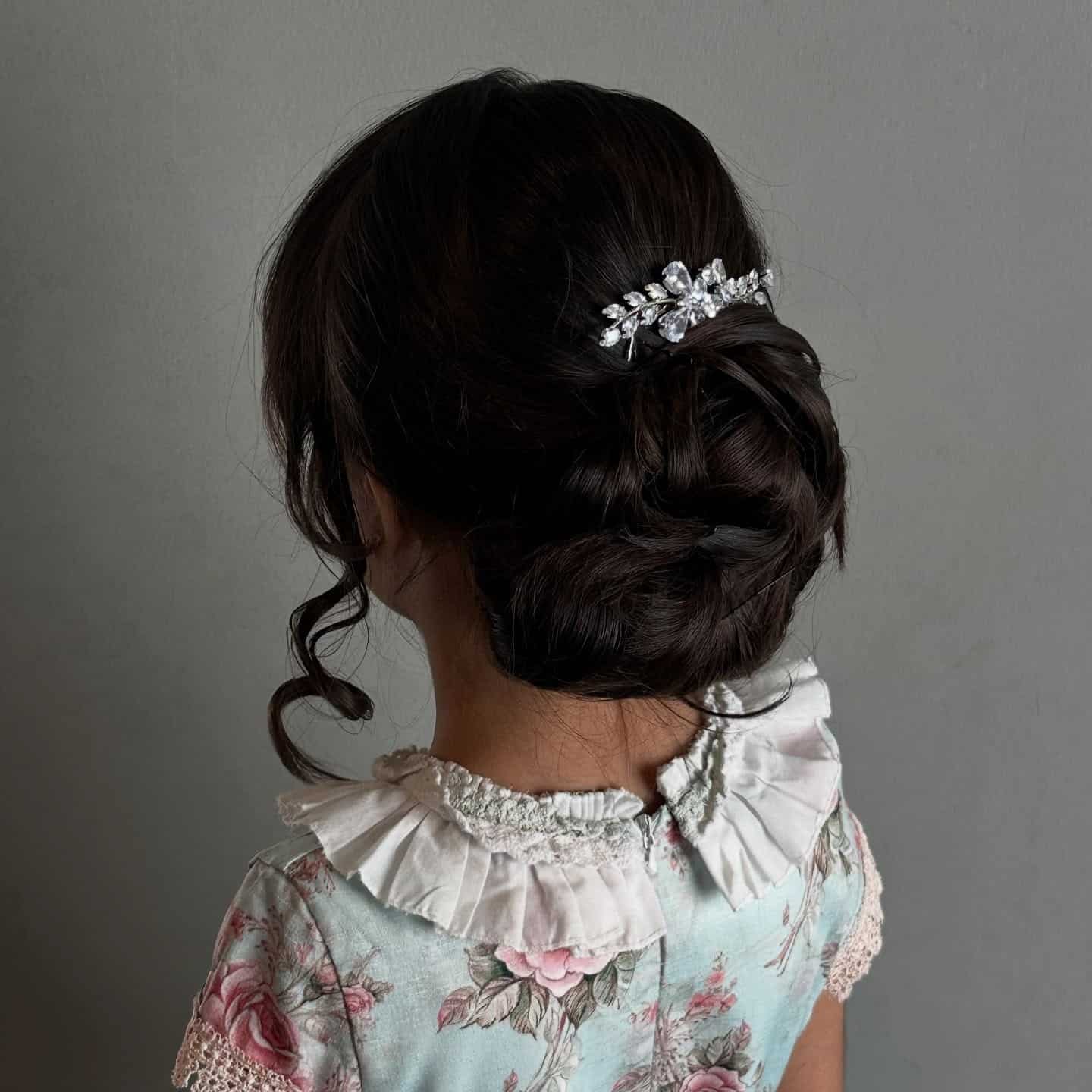 15. Dark Chocolate Low Messy Bun with Crystal Accent - Messy Bun Hairstyles
