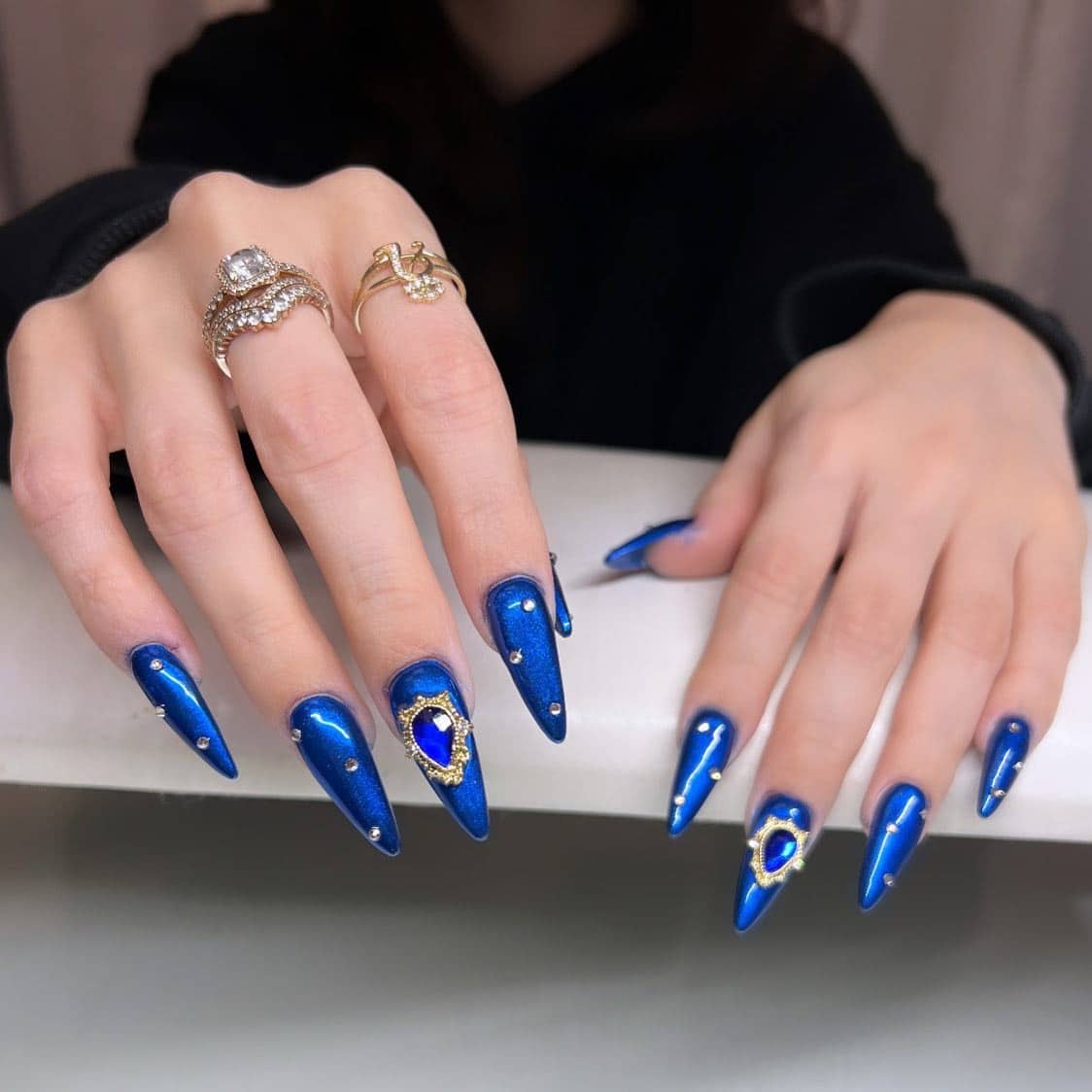 12. Royal Blue Chrome Stiletto Nails with Gem Accents - royal blue nail ideas