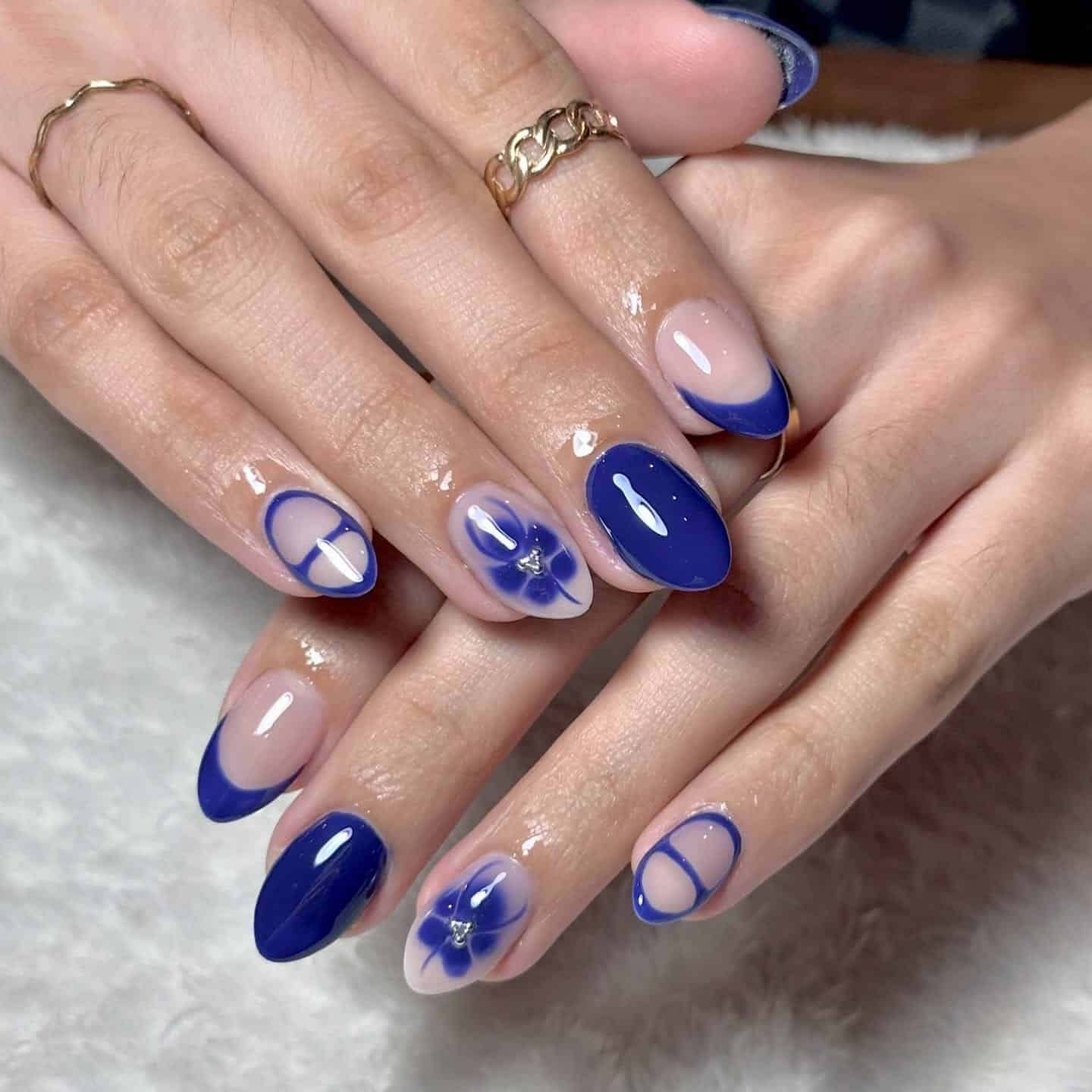 20. Royal Blue Minimalist Almond Nails with Floral Accent - royal blue nail ideas