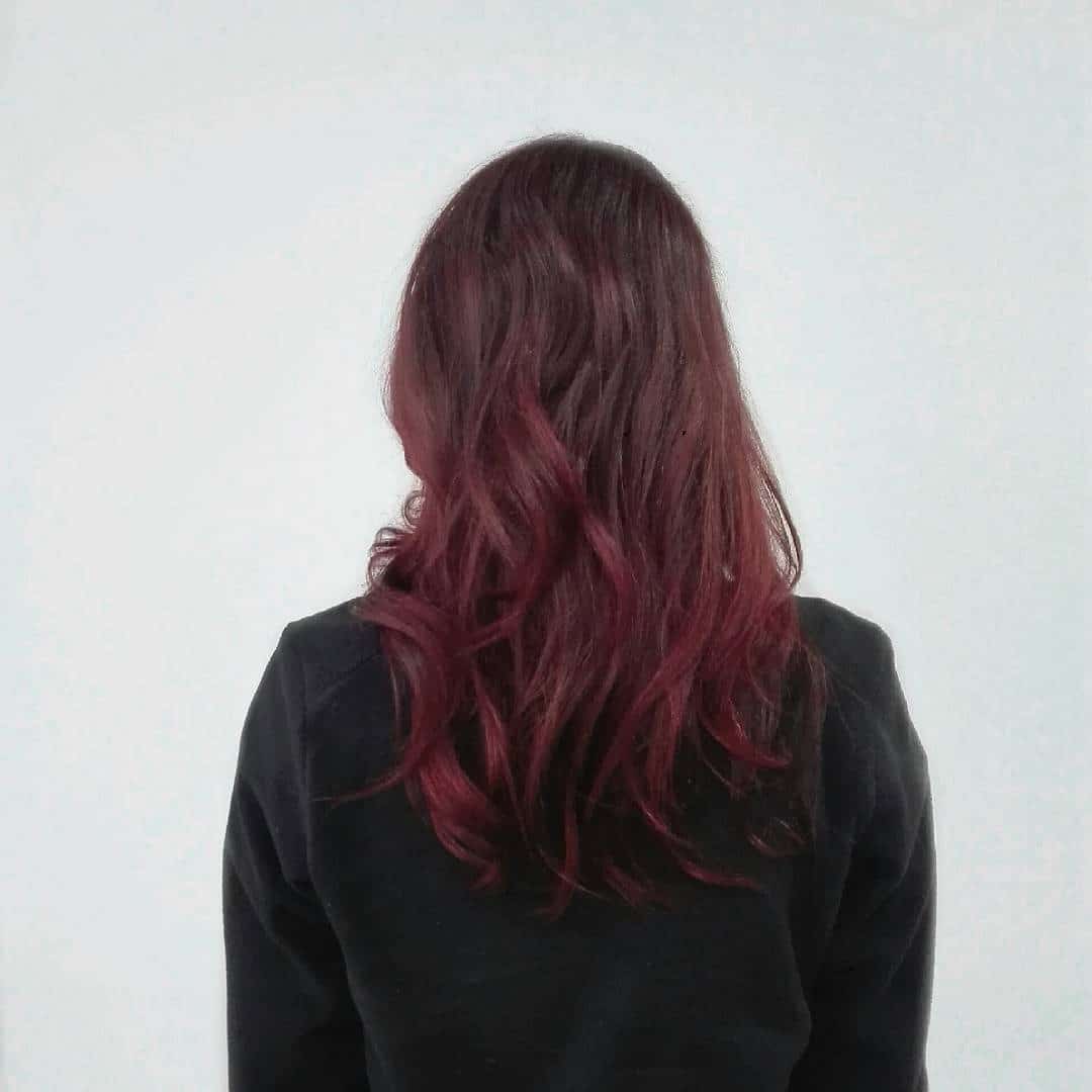 10. Deep Burgundy Layered Hair with Soft Waves - Deep Burgundy Hair Color
